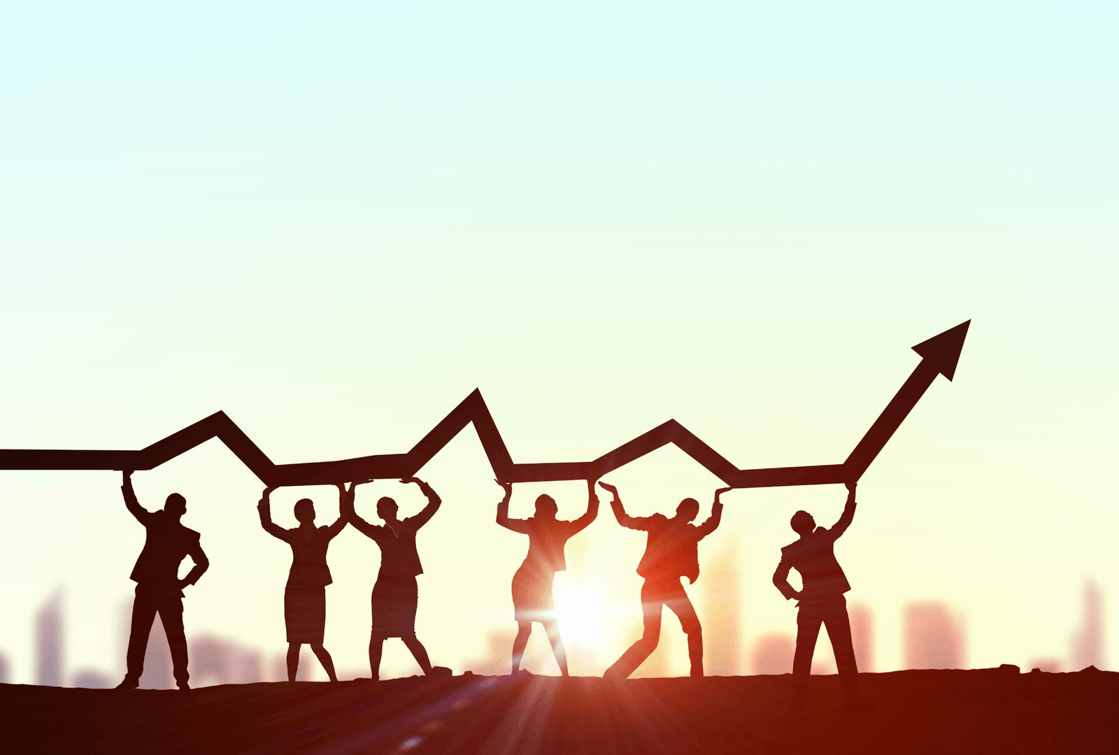 A silhouetted team supports an upward arrow symbolizing business growth and success in vocational education training.