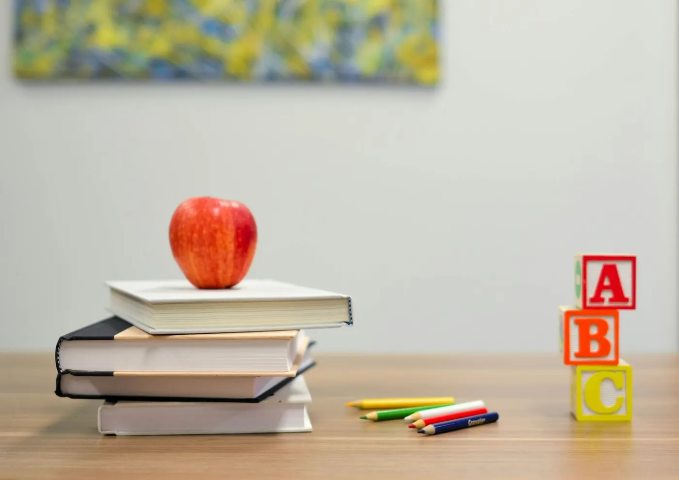 School supplies like books and pencils sit on a desk, illustrating resources for vocational education training.