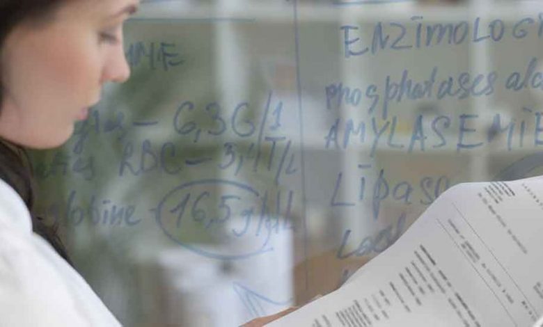 A scientist analyzes data in a laboratory setting while contextualising training and assessment resources for VET compliance.