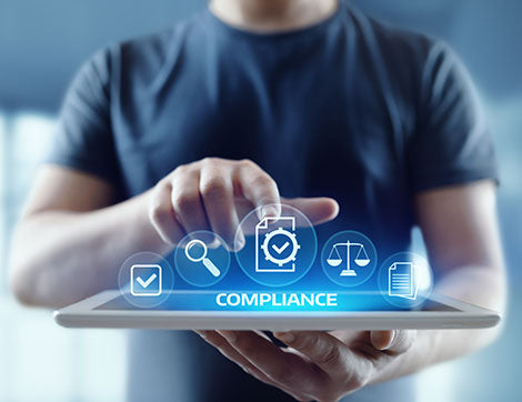 A person uses a tablet to view compliance information, highlighting the importance of vet compliance.