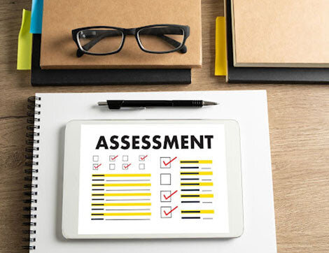 Assessment | Career Calling International An assessment checklist is shown on a tablet, relating to vet compliance and quality assurance.