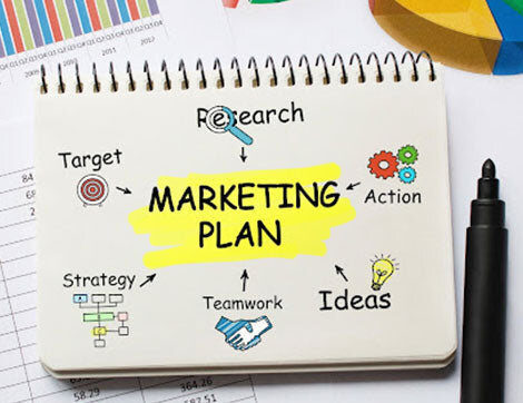 A notepad shows a marketing plan outlining research, strategy and teamwork for vet compliance.
