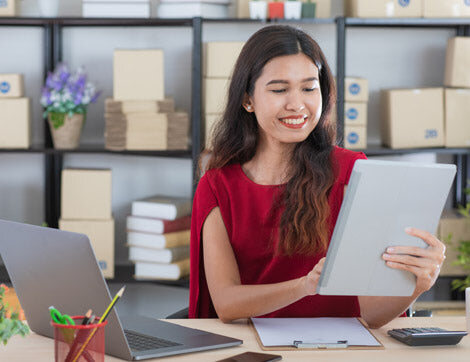 A woman reviews documents at a desk, showcasing Career Calling International's vet compliance services.