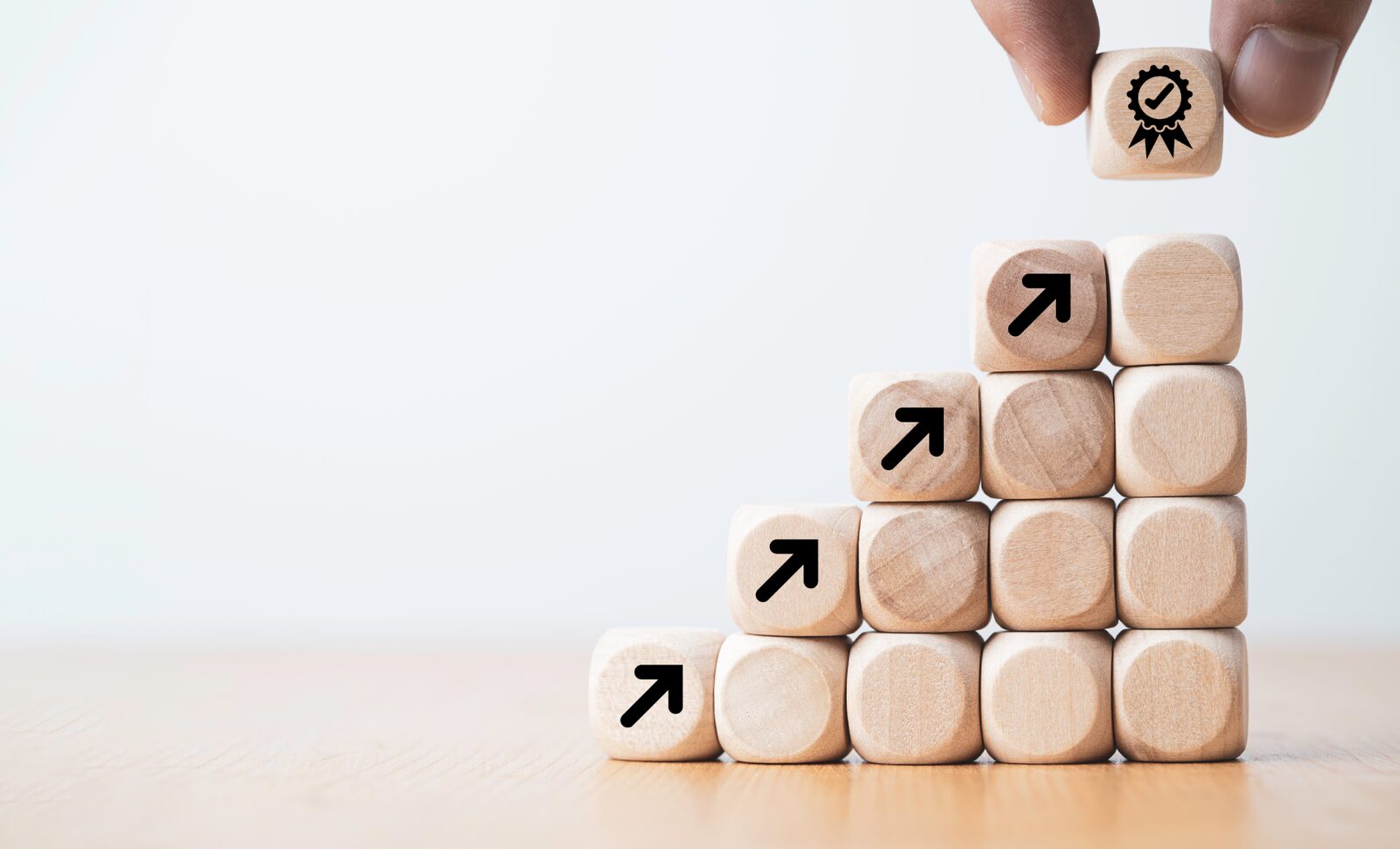 Wooden blocks stacked into ascending steps marked with upward arrows